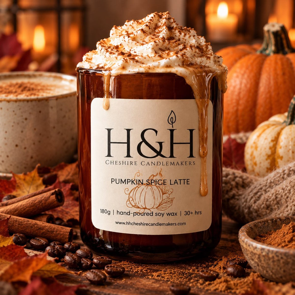 AI Close up of Pumpkin Spice Latte Candle  in amber jar with ivory H&H label with pumpkin vintage etching motif. Whipped cream on top and cream and coffee runs down the side of the jar. There is candlelight, pumpkins, coffee and cinnamon and coffee beans in the foreground.